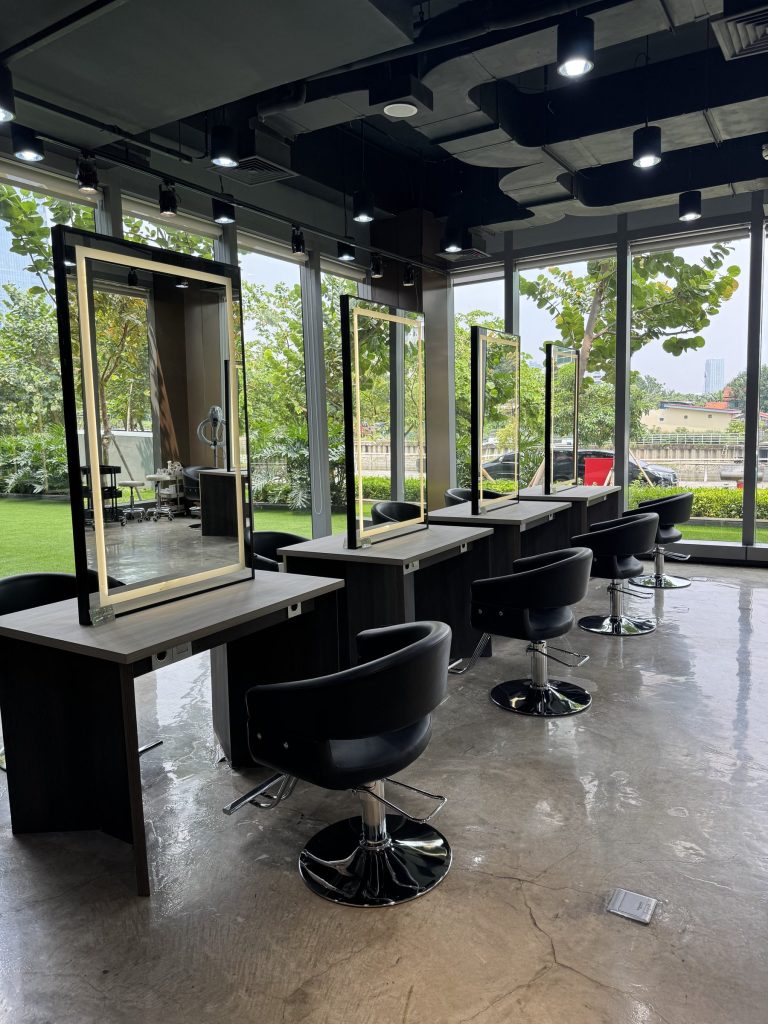 A styling chair and mirror by the window
