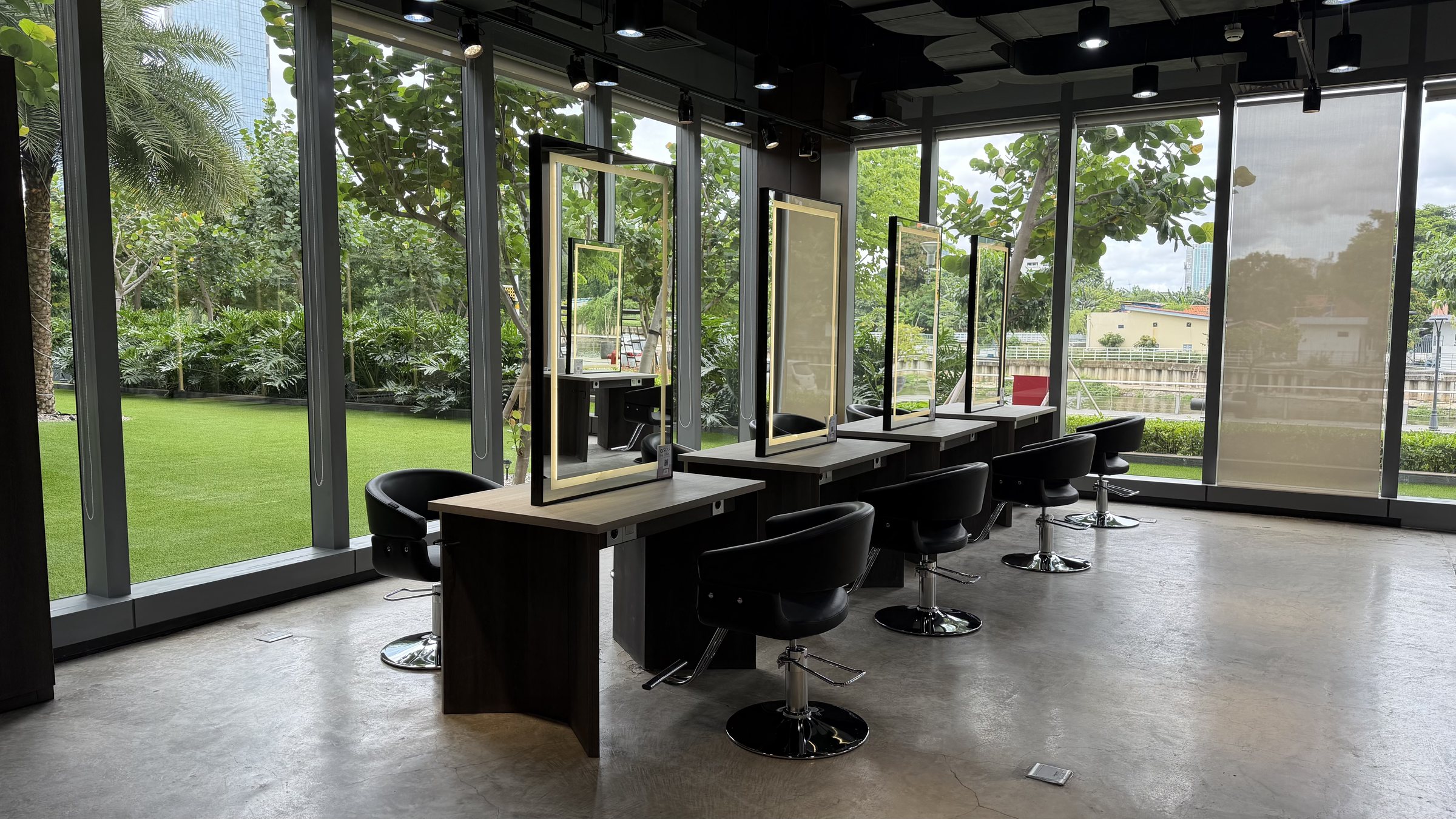 Styling chairs facing floor-to-ceiling windows and the garden